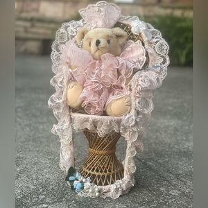 Vintage pink lace bear with wicker chair.